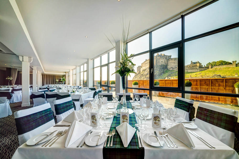 Heights at Apex Grassmarket Hotel Heights restaurant with tables dressed for an event and views looking onto Edinburgh Castle